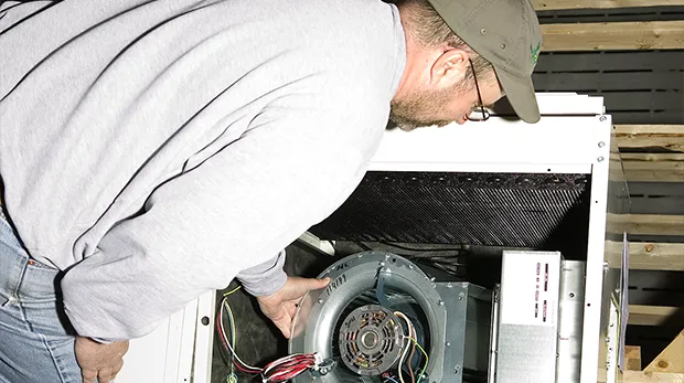 Technician working on refrigeration system