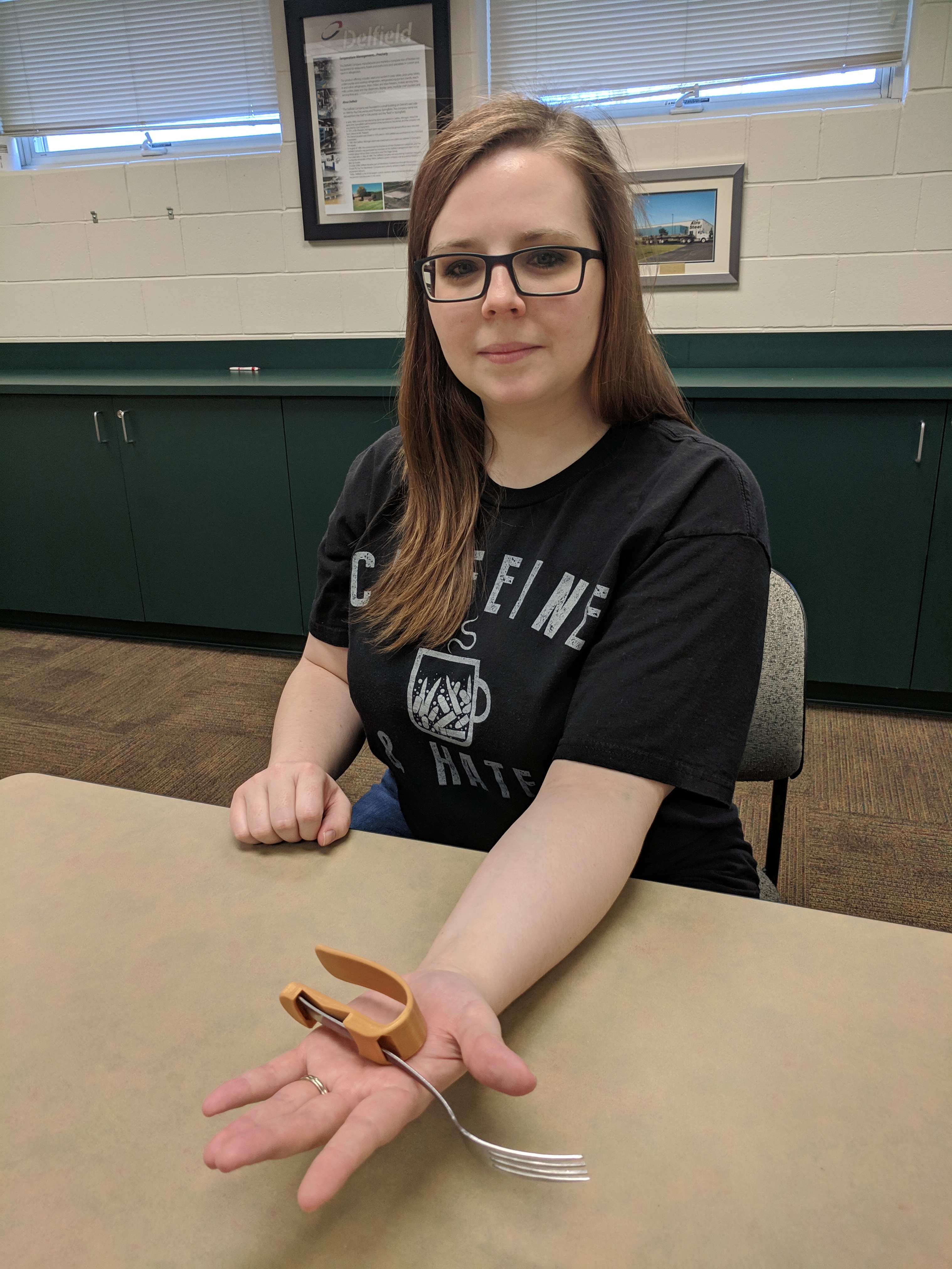 Beth displays her finished 3D printed product.