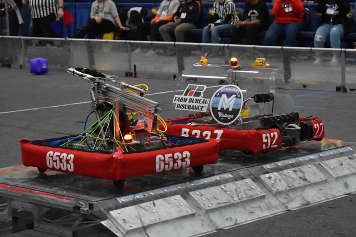 High school robotics team submissions face off at competition.