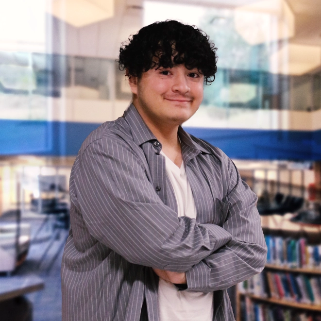 A Mid student in front of a blue background.