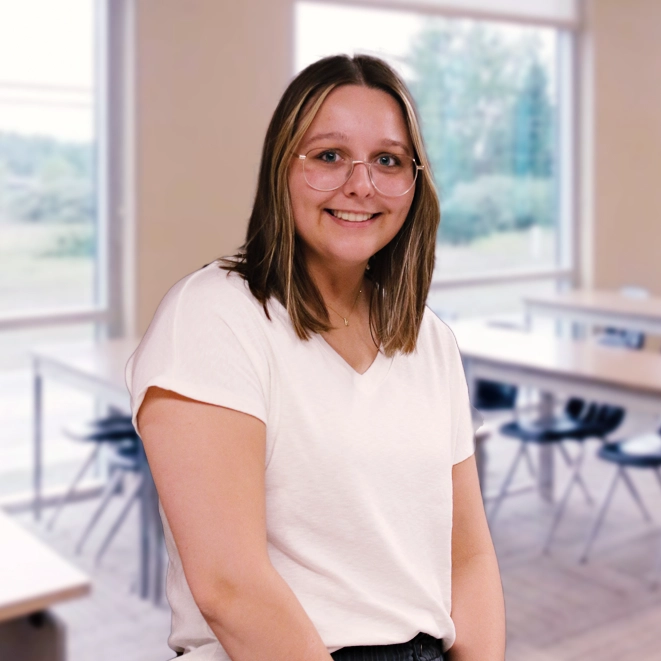 A Mid student in front of a blue background.